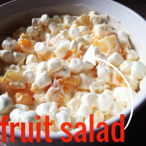 Fruit salad with crushed pineappple, mandarin oranges, coconut, sour cream and miniature marshmallows